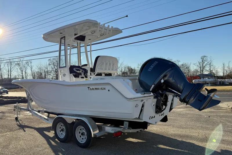 Slide: The Image of 2026 Tidewater 220 LXF boat on trailer with Yamaha outboard motor, parked outdoors. - 16