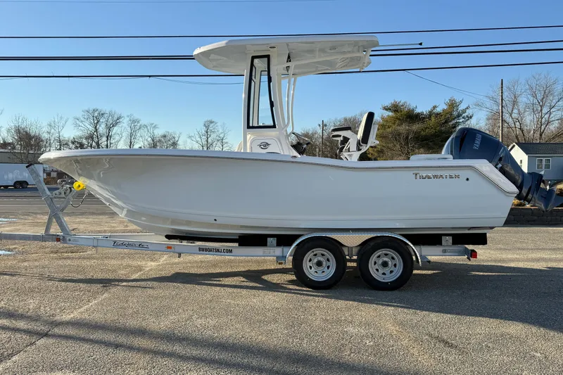 Slide: The Image of 2026 Tidewater 220 LXF boat on trailer, side view, clear sky background. - 19