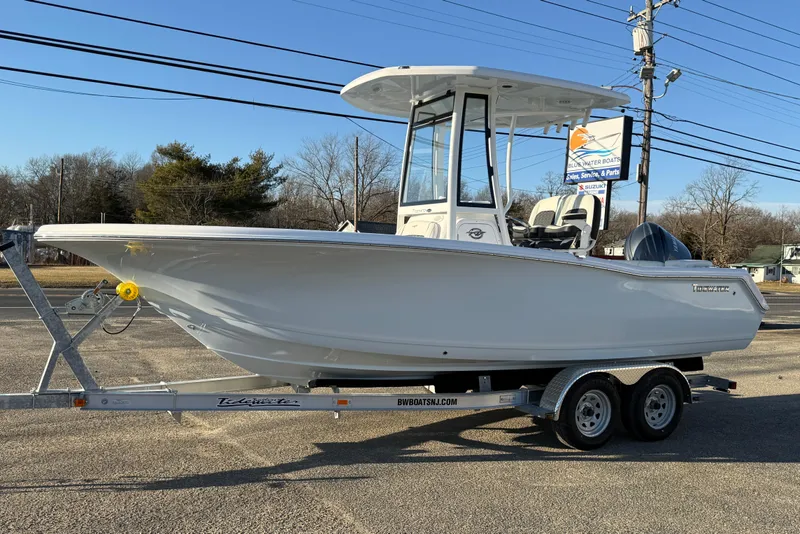 Slide: The Image of 2026 Tidewater 220 LXF boat on trailer, parked outdoors, clear sky background. - 20