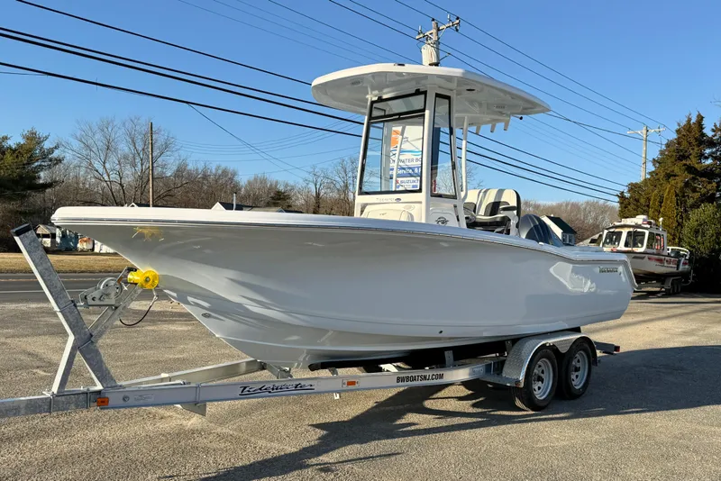 Slide: The Image of 2026 Tidewater 220 LXF boat on trailer, parked outdoors, clear sky background. - 21