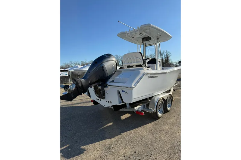 Slide: The Image of 2026 Tidewater 220 LXF boat on trailer with outboard motor, parked outdoors. - 23