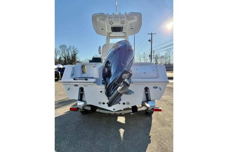 Slide: The Image of 2026 Tidewater 220 LXF boat with outboard motor, parked on a trailer. - 24