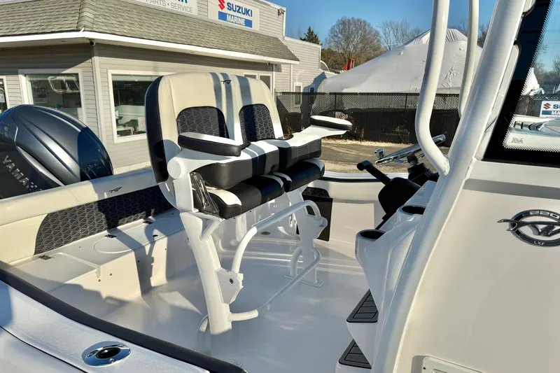 Slide: The Image of 2026 Tidewater 220 LXF boat interior with dual seating and steering console. - 8