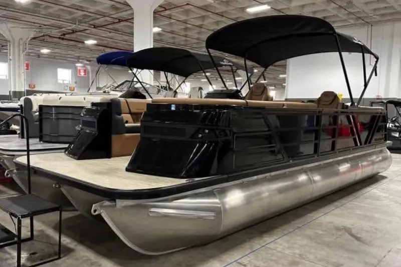 The Image of 2024 Veranda Vertex VX25RC pontoon boat displayed indoors with sleek design and canopy. - 1