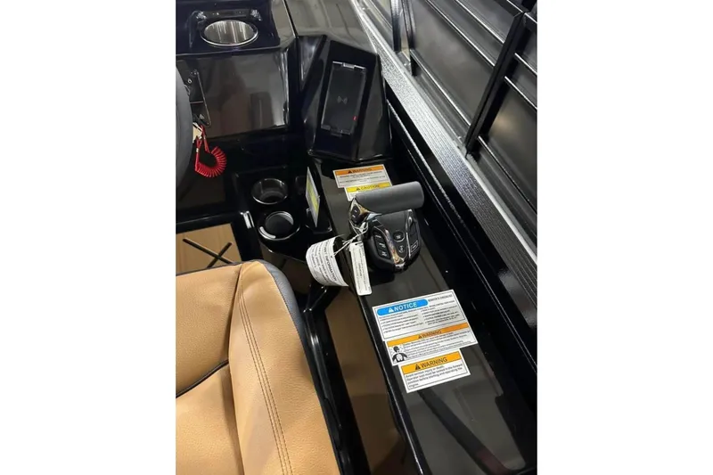 Slide: The Image of 2024 Veranda Vertex VX25RC boat console with controls and warning labels. - 12