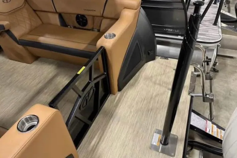 Slide: The Image of 2024 Veranda Vertex VX25RC boat interior with tan seating and cup holders. - 13