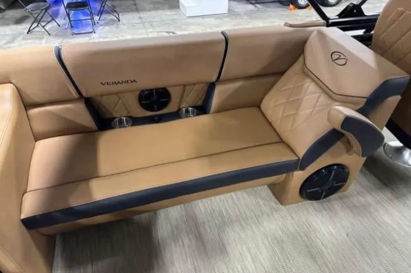 Slide: The Image of Luxurious tan seating in 2024 Veranda Vertex VX25RC boat, featuring cup holders and speakers. - 15