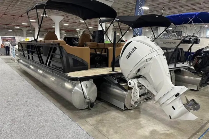 Slide: The Image of 2024 Veranda Vertex VX25RC pontoon boat with Yamaha outboard motor at indoor exhibition. - 2