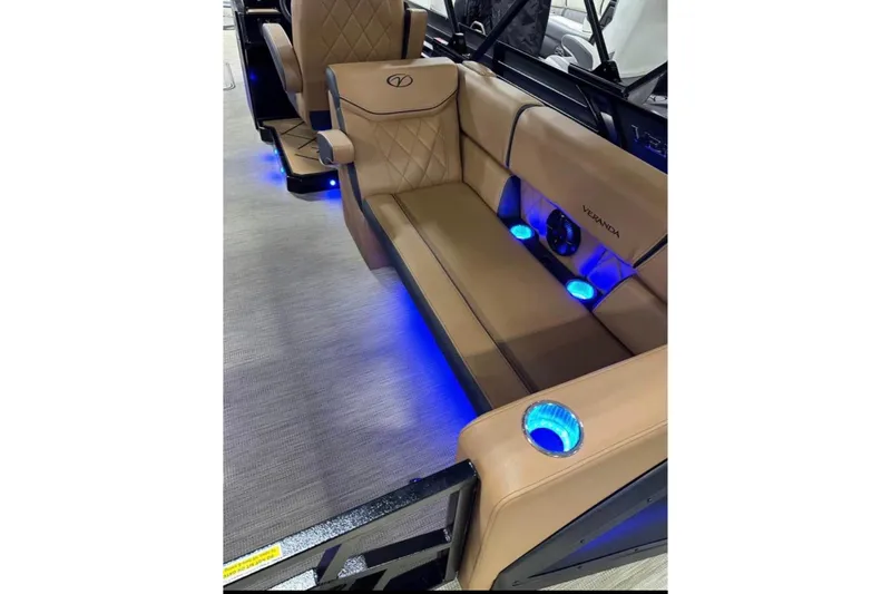 Slide: The Image of Luxurious 2024 Veranda Vertex VX25RC boat interior with tan seating and blue LED lighting. - 9