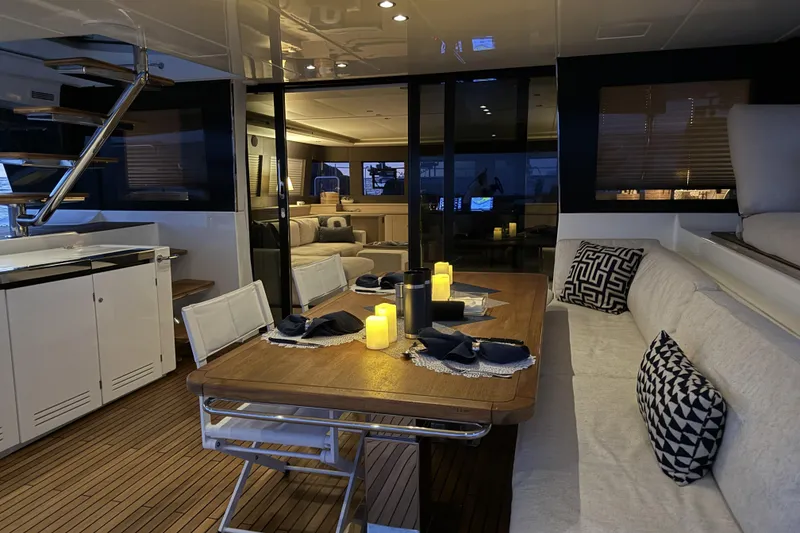 Slide: The Image of Luxurious interior of 2020 Lagoon 630 Motor Yacht with elegant dining area and ambient lighting. - 2