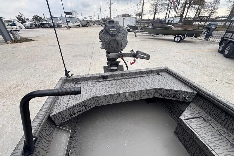 Slide: The Image of 2023 Gator Tail Extreme series boat with camo design and powerful motor in a dealership lot. - 10