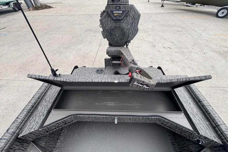 Slide: The Image of 2023 Gator Tail Extreme series boat with open storage compartment and motor, on concrete surface. - 11