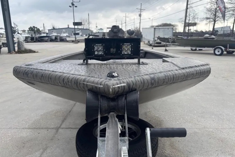 Slide: The Image of 2023 Gator Tail Extreme series boat on trailer, featuring camo design and LED lights. - 2