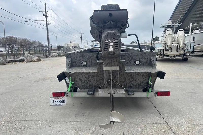 Slide: The Image of 2023 Gator Tail Extreme series boat on trailer, rear view with motor and propeller visible. - 6