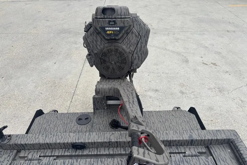 Slide: The Image of 2023 Gator Tail Extreme series boat motor with camo design on concrete surface. - 9