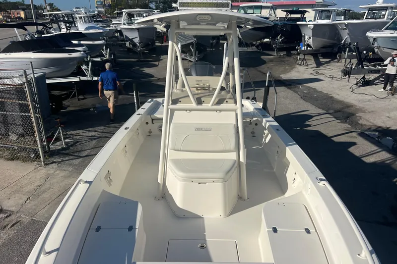Slide: The Image of 2017 Pathfinder 2600 TRS boat in a marina, surrounded by other vessels. - 12