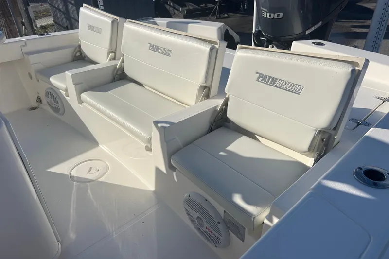 Slide: The Image of 2017 Pathfinder 2600 TRS boat interior with white seating and Yamaha 300 engine. - 17