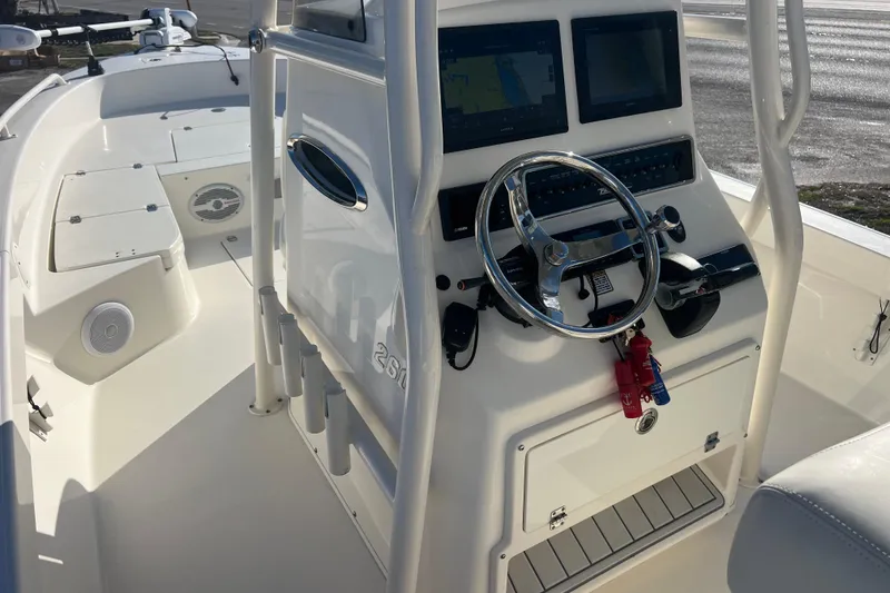 Slide: The Image of 2017 Pathfinder 2600 TRS boat interior with steering console and navigation screens. - 8