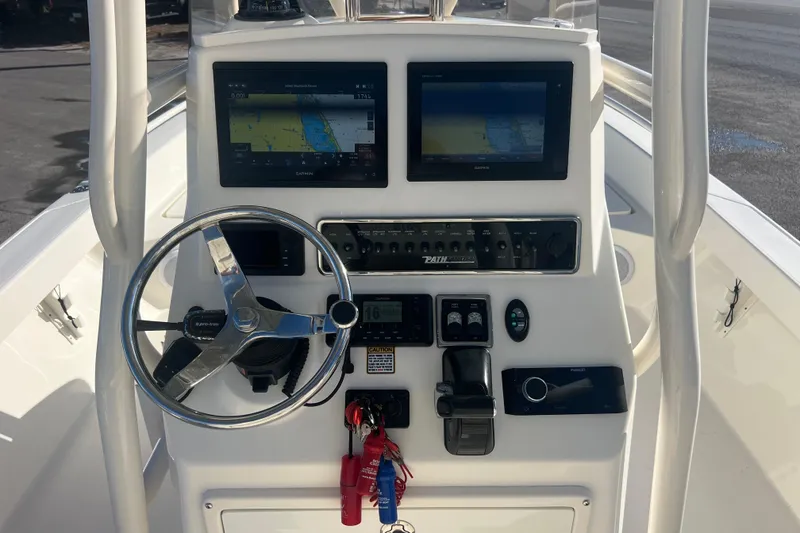 Slide: The Image of 2017 Pathfinder 2600 TRS boat console with steering wheel and navigation screens. - 9