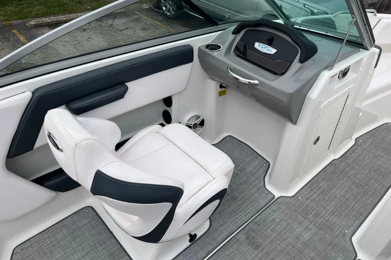 Slide: The Image of 2020 Chaparral 21 SSi Ski & Fish boat interior with white seating and dashboard. - 10