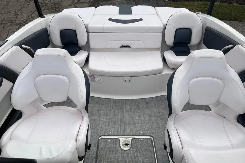 Slide: The Image of 2020 Chaparral 21 SSi Ski & Fish boat interior with white seating and gray flooring. - 11