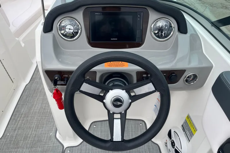 Slide: The Image of 2020 Chaparral 21 SSi Ski & Fish boat dashboard with steering wheel and gauges. - 14