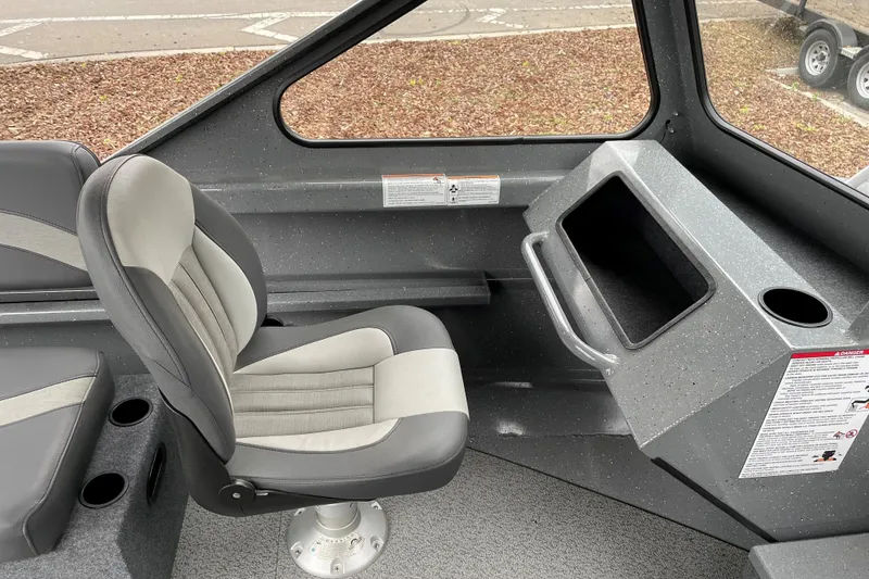 Slide: The Image of 2024 Spartan 185 Astoria boat interior with gray seating and console. - 11