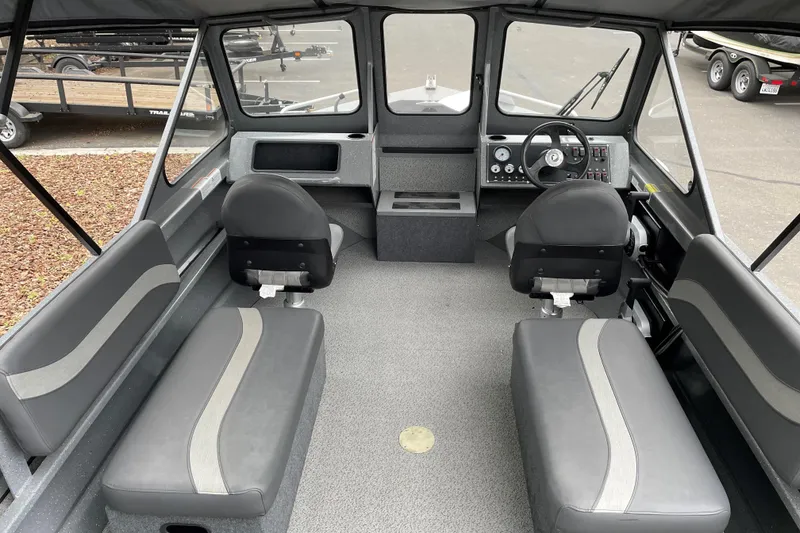 Slide: The Image of 2024 Spartan 185 Astoria boat interior with seating and control panel. - 4