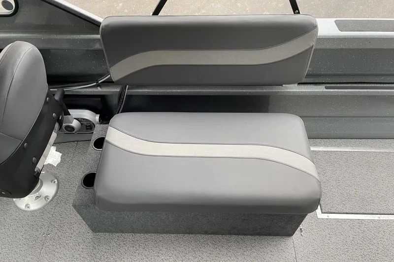 Slide: The Image of 2024 Spartan 185 Astoria boat interior seating with gray upholstery and cup holders. - 5