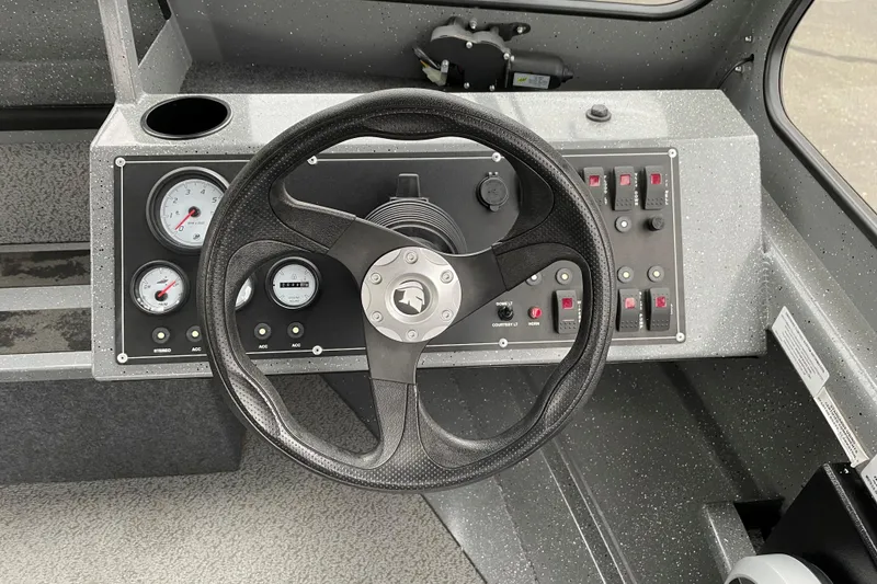 Slide: The Image of 2024 Spartan 185 Astoria boat dashboard with steering wheel and control panel. - 7