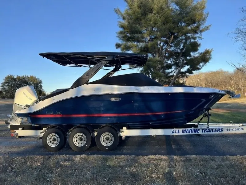 The Image of 2024 Sea Ray SLX 260 Outboard on a trailer outdoors. - 0