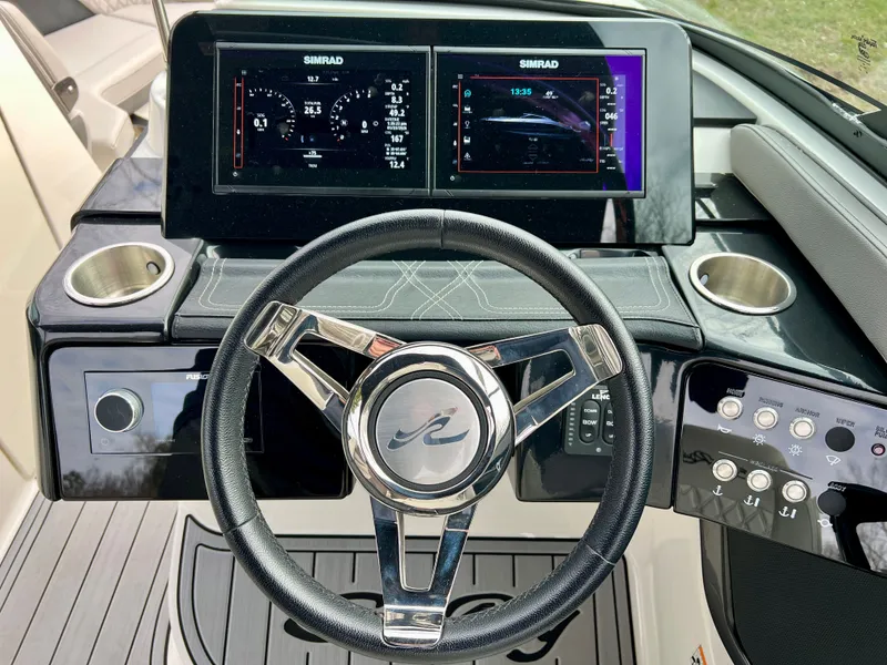 Slide: The Image of 2024 Sea Ray SLX 260 Outboard helm with Simrad displays. - 13