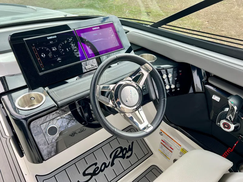 Slide: The Image of 2024 Sea Ray SLX 260 Outboard cockpit with modern controls. - 14