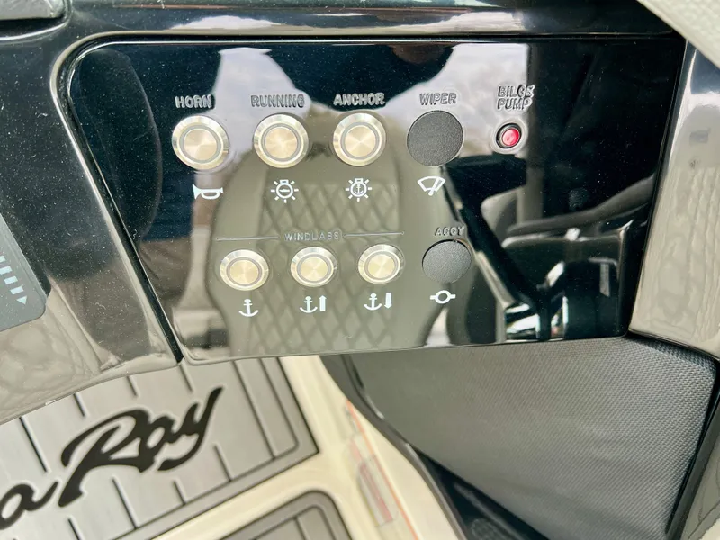 Slide: The Image of Control panel of 2024 Sea Ray SLX 260 Outboard with various switches. - 15