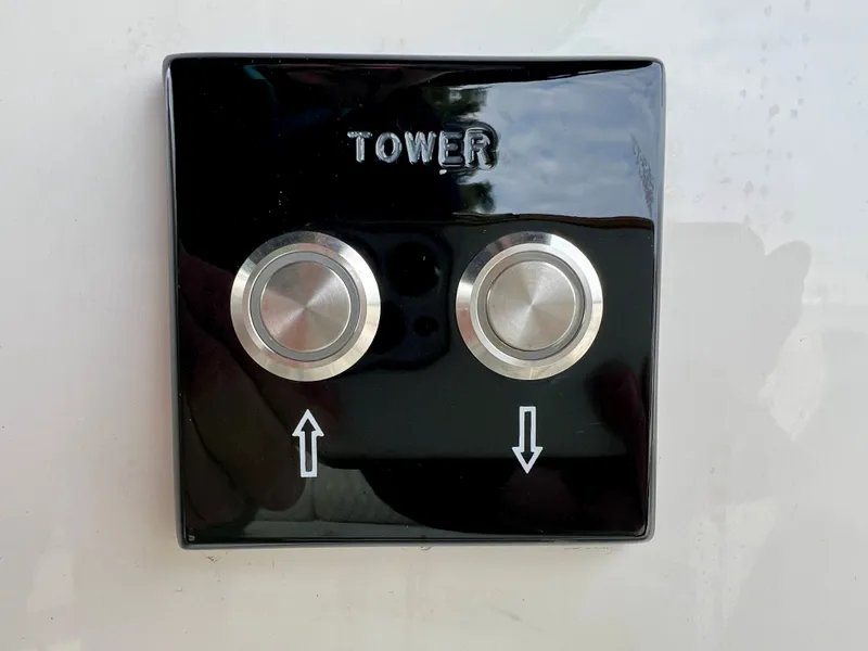 Slide: The Image of Black control panel with two buttons on Sea Ray SLX 260 Outboard 2024. - 17