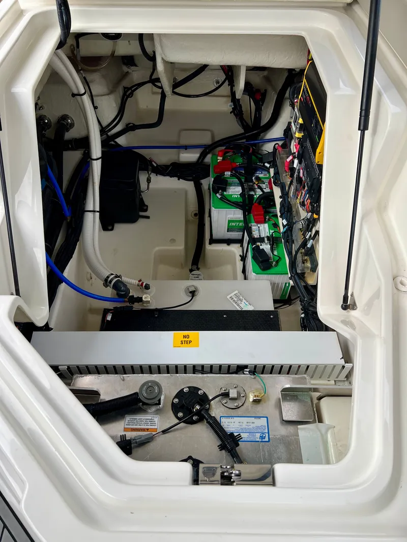 Slide: The Image of Engine compartment of 2024 Sea Ray SLX 260 Outboard with batteries and wiring. - 26