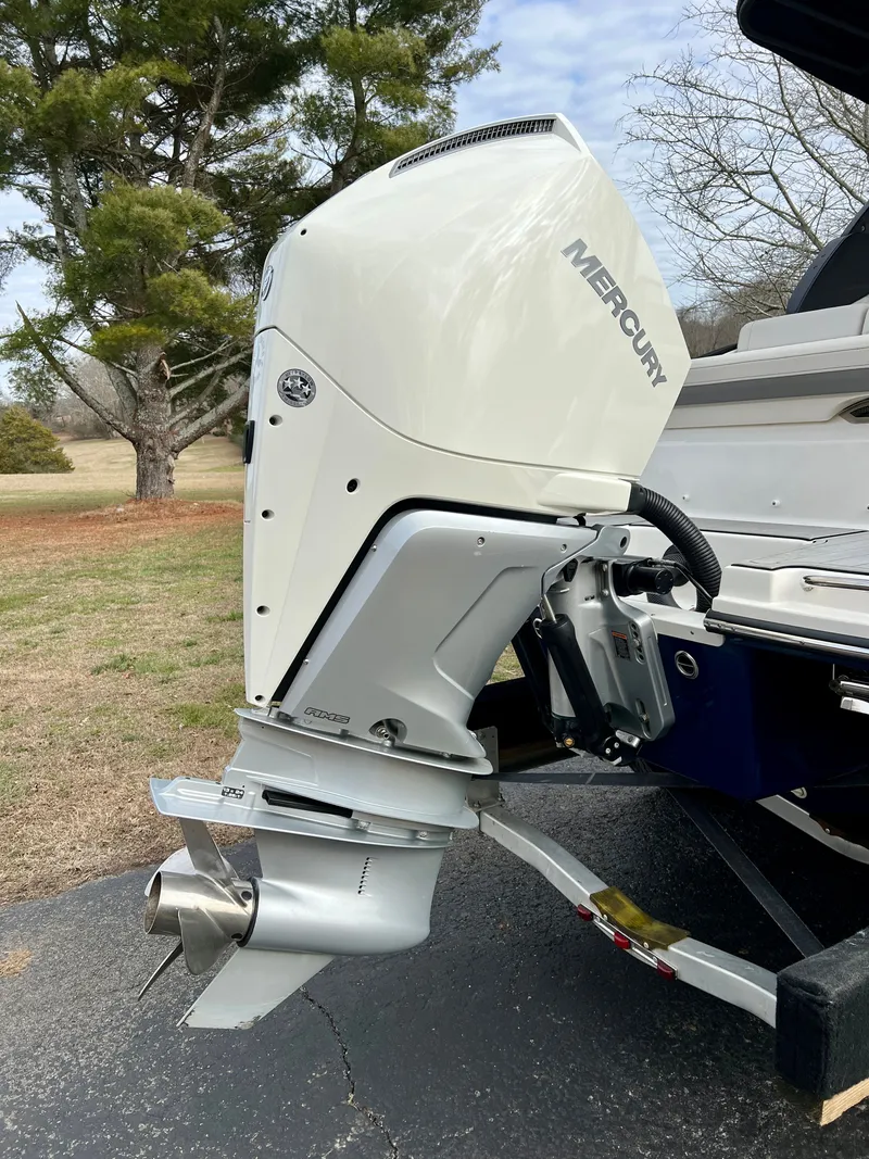 Slide: The Image of 2024 Sea Ray SLX 260 outboard motor on a trailer. - 28