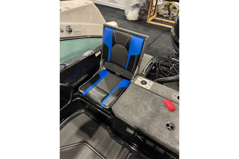 Slide: The Image of 2026 Skeeter Solera 205 boat seat, blue and black design, on a carpeted deck. - 8