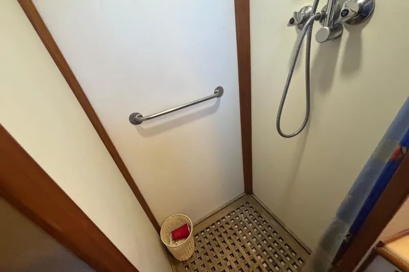 Slide: The Image of Shower area in 1989 Grand Banks 46 Classic yacht with handheld showerhead and wooden floor. - 109