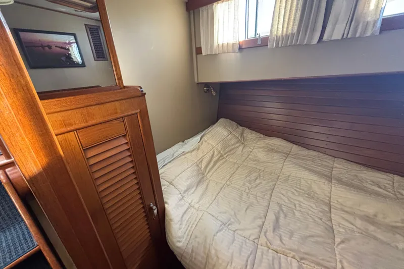 Slide: The Image of Cozy cabin interior of 1989 Grand Banks 46 Classic yacht with wooden paneling and bed. - 119