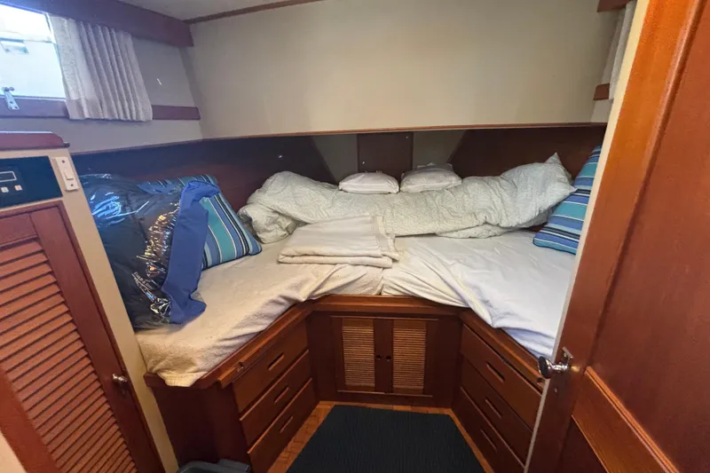 Slide: The Image of Cozy cabin interior of 1989 Grand Banks 46 Classic yacht with comfortable bedding. - 128