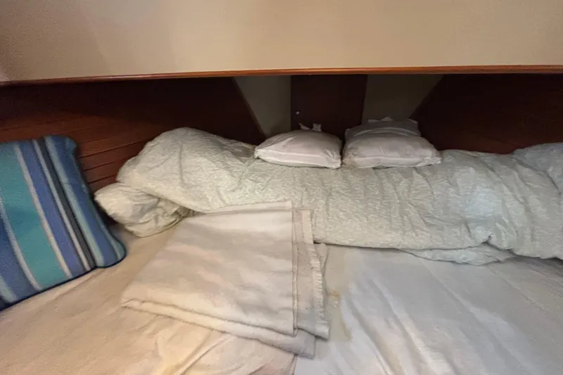 Slide: The Image of Cozy cabin bed with pillows and blanket on 1989 Grand Banks 46 Classic yacht. - 130