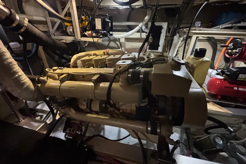 Slide: The Image of Engine room of a 1989 Grand Banks 46 Classic yacht, showcasing mechanical components. - 135