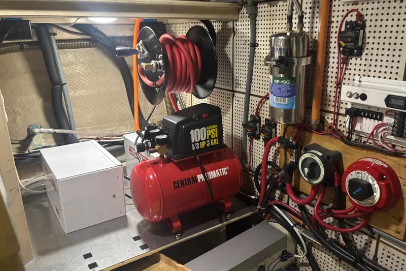 Slide: The Image of Engine room of 1989 Grand Banks 46 Classic with air compressor and electrical components. - 139