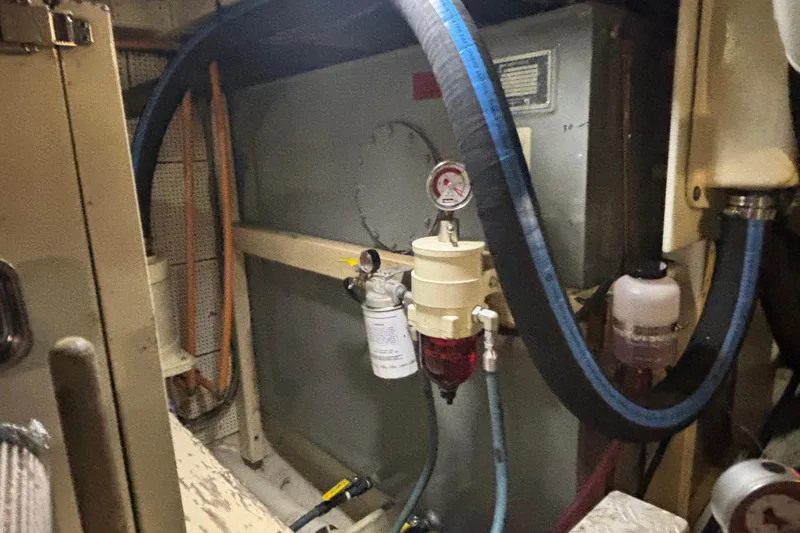 Slide: The Image of Engine room of 1989 Grand Banks 46 Classic with fuel filtration system and hoses. - 148