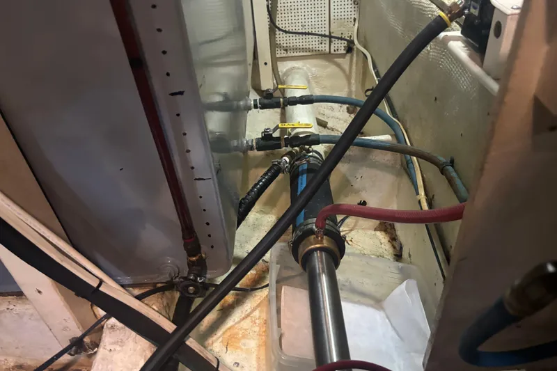 Slide: The Image of Engine room of 1989 Grand Banks 46 Classic with visible pipes and valves. - 152