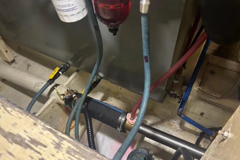 Slide: The Image of Engine room of 1989 Grand Banks 46 Classic with visible hoses and fittings. - 153