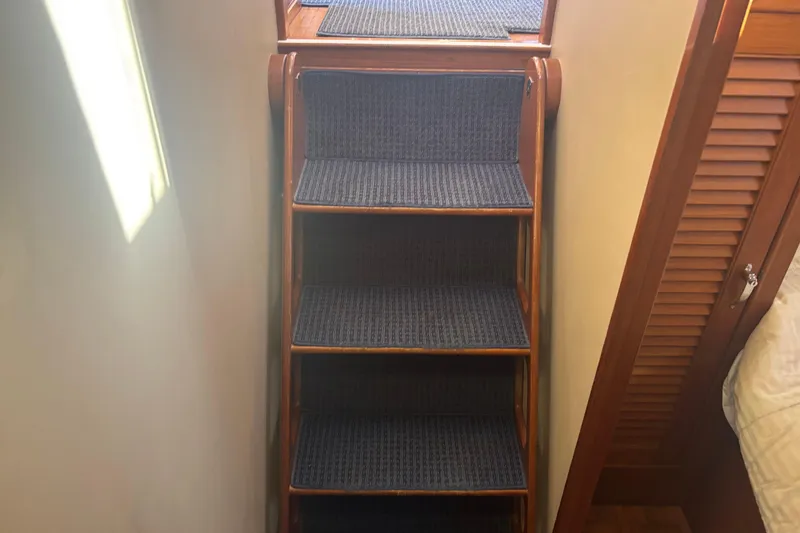 Slide: The Image of Wooden staircase with blue carpet on a 1989 Grand Banks 46 Classic yacht. - 156