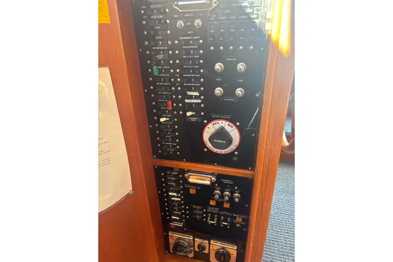 Slide: The Image of Control panel of 1989 Grand Banks 46 Classic yacht with various switches and dials. - 158