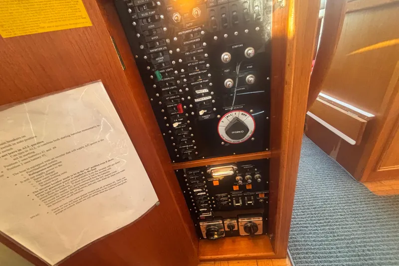 Slide: The Image of Electrical panel of a 1989 Grand Banks 46 Classic yacht, featuring switches and controls. - 161